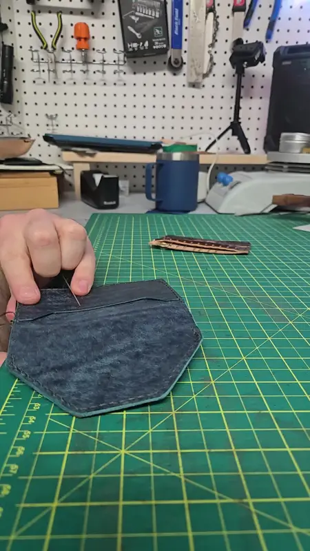 Trimming a fresh indigo piece — Rogue Artisan leather workshop, East Vancouver