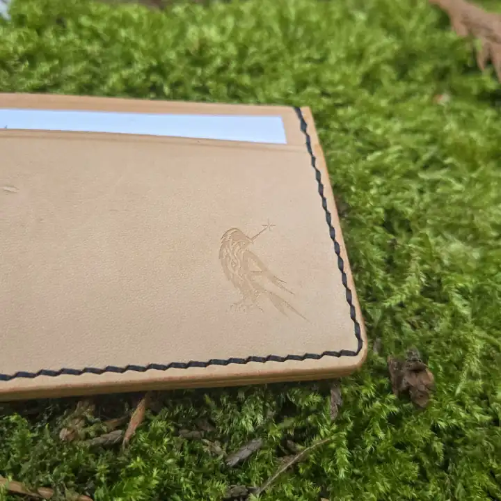 Natural tan wallet with the raven mark, up close — Rogue Artisan, East Vancouver